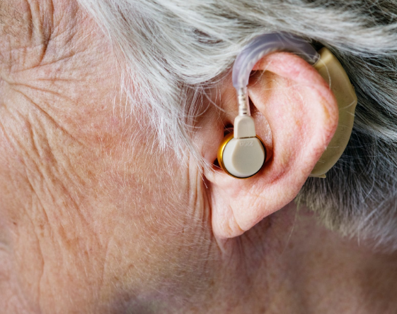 an elderly person wearing a hearing aid