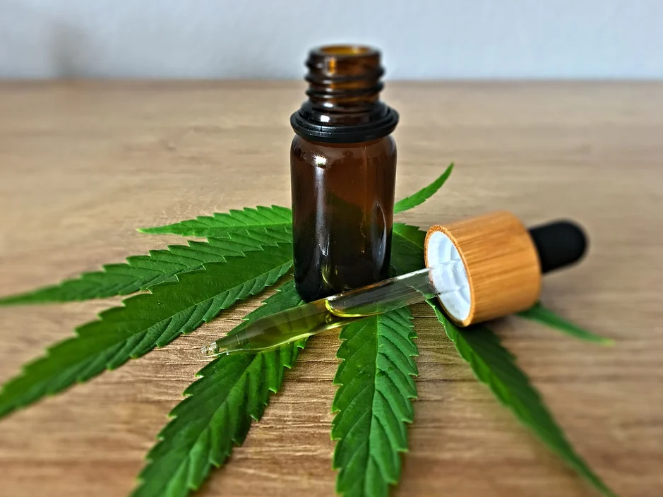 CBD oil bottle on hemp leaf